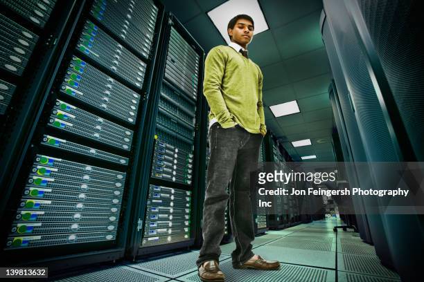 businessman standing in server room - low angle view stock-fotos und bilder