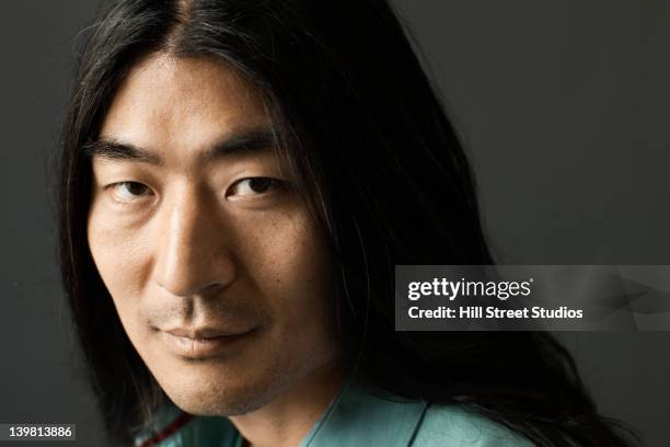 serious korean man with long hair - asian man long hair stock pictures, royalty-free photos & images