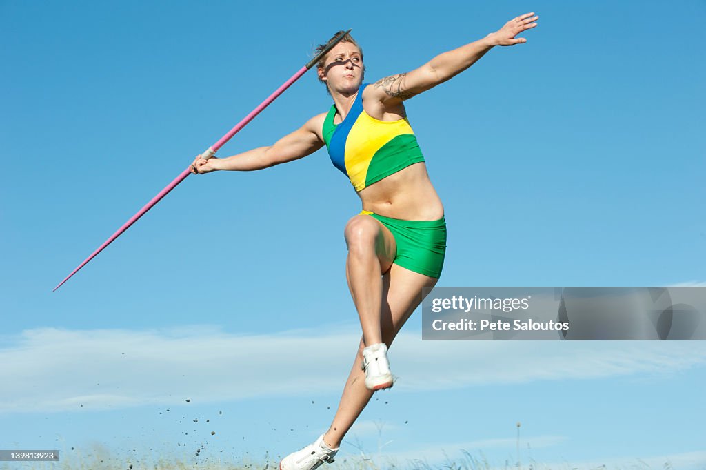 Caucasian athlete throwing javelin
