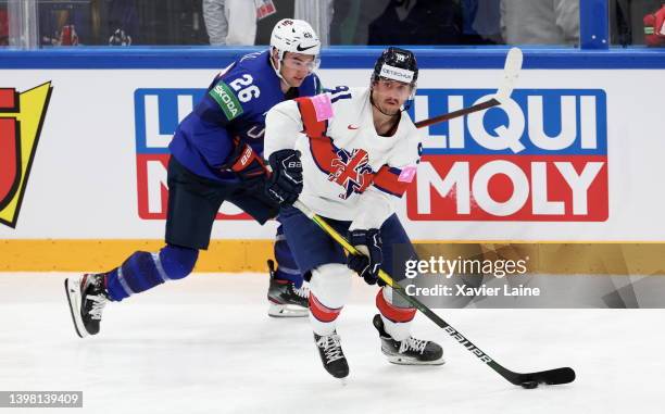 Sean Farell of Team United States in action with Ben Lake Team England during the 2022 IIHF Ice Hockey World Championship Group B match between...