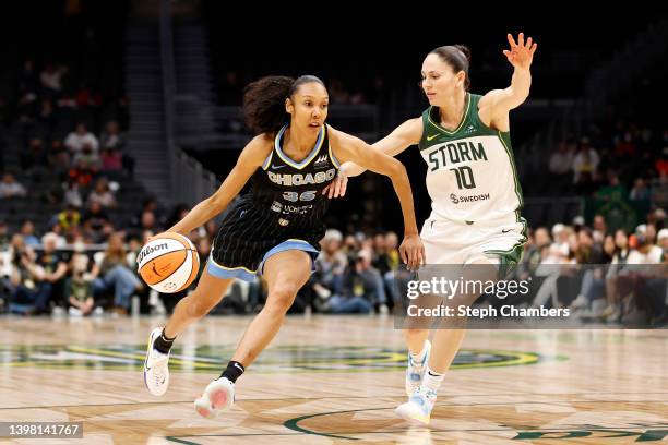 Rebekah Gardner of the Chicago Sky dribbles against Sue Bird of the Seattle Storm during the first half at Climate Pledge Arena on May 18, 2022 in...