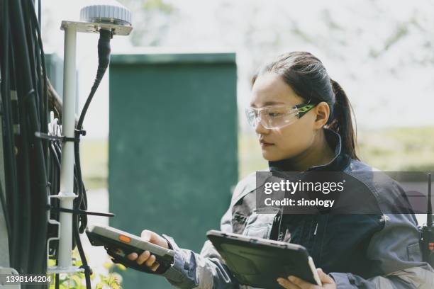 asian female communication engineer is checking 5g   transmitter antenna - 5g tower stock pictures, royalty-free photos & images
