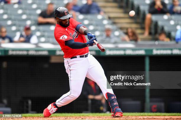 Franmil Reyes of the Cleveland Guardians hits a sacrifice fly ball to score Owen Miller during the second inning against the Cincinnati Reds at...