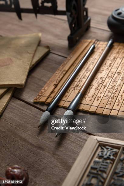 the bamboo slips on the desktop and brushes - table font view stock pictures, royalty-free photos & images