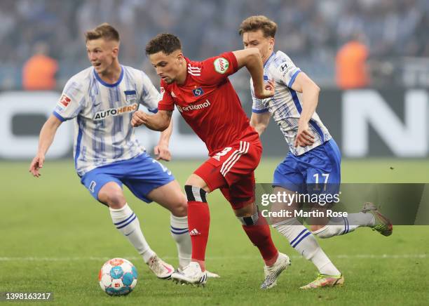 Moritz Heyer of Hamburger SV is challenged by Peter Pekarik and Maximilian Mittelstaedt of Hertha BSC during the Bundesliga Playoffs Leg One match...