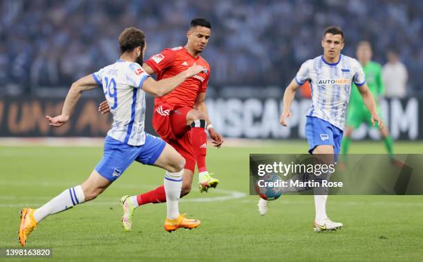 Robert Glatzel of Hamburger SV controls the ball whilst under pressure from Lucas Tousart of Hertha BSC during the Bundesliga Playoffs Leg One match...