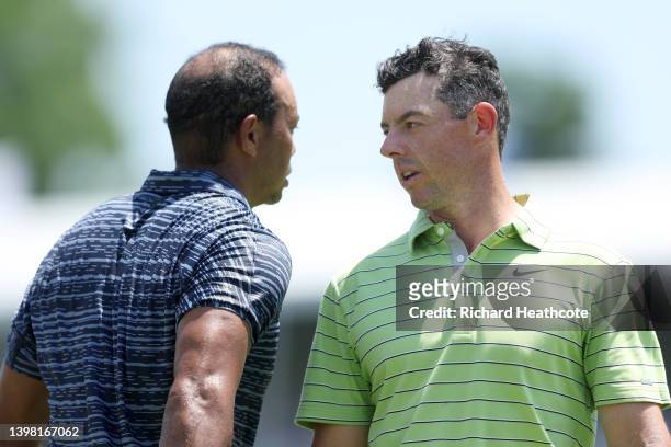 Tiger Woods of the United States and Rory McIlroy of Northern Ireland shake hands as they finish their round on the ninth green during the first...
