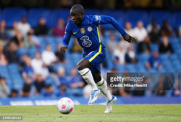 Ngolo Kante of Chelsea runs with the ball during the Premier League match between Chelsea and Leicester City at Stamford Bridge on May 19, 2022 in...