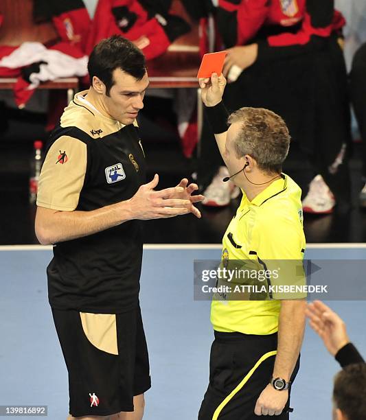 Spanish Isaias Guardiola of BM Atletico Madrid receives a red card from Slovenian referee Peter Ljubic against Hungarian MKB Veszprem in the local...