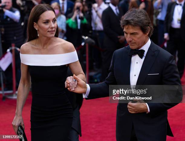 Catherine, Duchess of Cambridge is accompanied by star actor Tom Cruise as she arrives for the "Top Gun: Maverick" Royal Film Performance at Odeon...