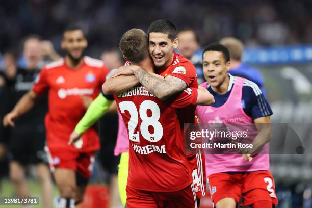 Ludovit Reis of Hamburger SV celebrates with team mate Miro Muheim after scoring their sides first goal during the Bundesliga Playoffs Leg One match...