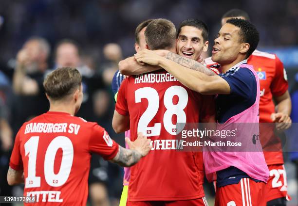 Ludovit Reis of Hamburger SV celebrates with team mates Miro Muheim and Jan Gyamerah after scoring their sides first goal during the Bundesliga...
