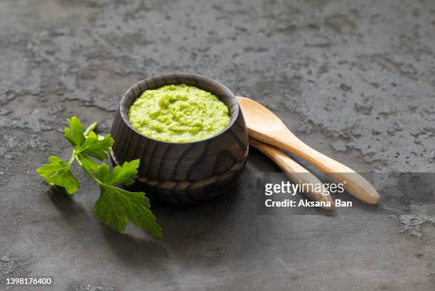 light appetizer, green horseradish wasabi in a wooden saucepan. dark gray background. rustic style - rábano picante fotografías e imágenes de stock