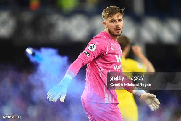 Jack Butland of Crystal Palace reacts as a flare is thrown onto the pitch during the Premier League match between Everton and Crystal Palace at...