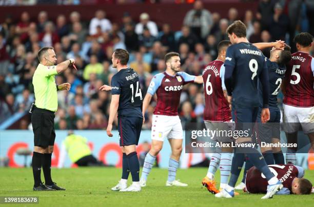 Matthew Lowton of Burnley holds his head as he is sent off by referee Paul Tierney during the Premier League match between Aston Villa and Burnley at...