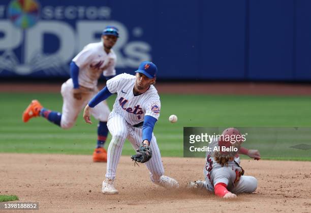 Jeff McNeil of the New York Mets cannot get to the ball as Harrison Bader of the St. Louis Cardinals slides safely into second base during their game...