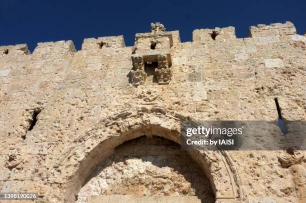 a sunny day at zion gate against sky with bullet holes , the old city of jerusalem - arab israeli conflict stock pictures, royalty-free photos & images