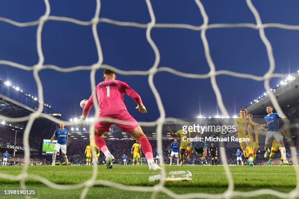 Dominic Calvert-Lewin of Everton scores their sides third goal past Jack Butland of Crystal Palace during the Premier League match between Everton...