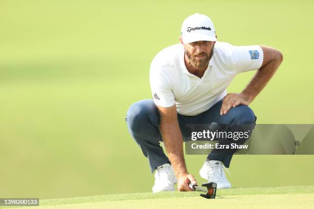 Dustin Johnson of the United States lines up a putt on the 17th green during the first round of the 2022 PGA Championship at Southern Hills Country...