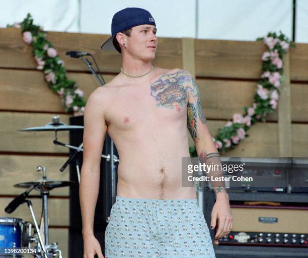 American musician, singer, songwriter, author, record producer, actor, and filmmaker Tom DeLonge, of the American rock band Blink-182, stands on...