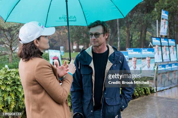 Independent candidate for Wentworth Allegra Spender speaks to actor and Wentworth resident Simon Baker outside the pre-polling booth at the Margaret...