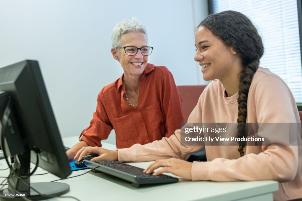 High school student receiving help from tutor after school