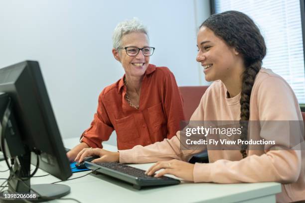 high school student receiving help from tutor after school - student advisor stock pictures, royalty-free photos & images