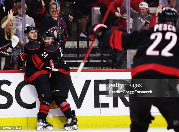 Sebastian Aho of the Carolina Hurricanes scores a game tying goal and celebrates with teammate Seth Jarvis in Game One of the Second Round of the...