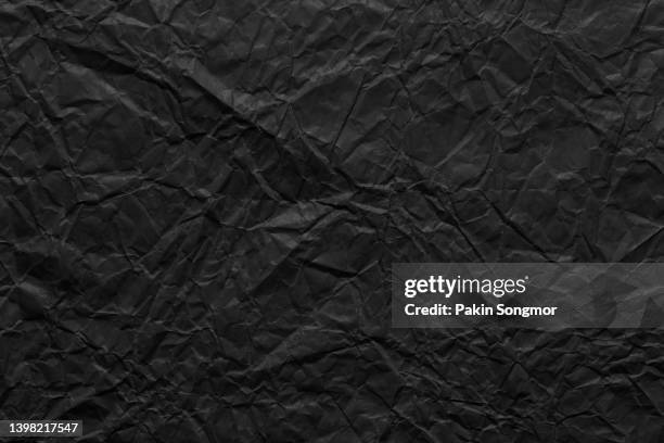 black wrinkled paper texture background. - black craft paper stock pictures, royalty-free photos & images