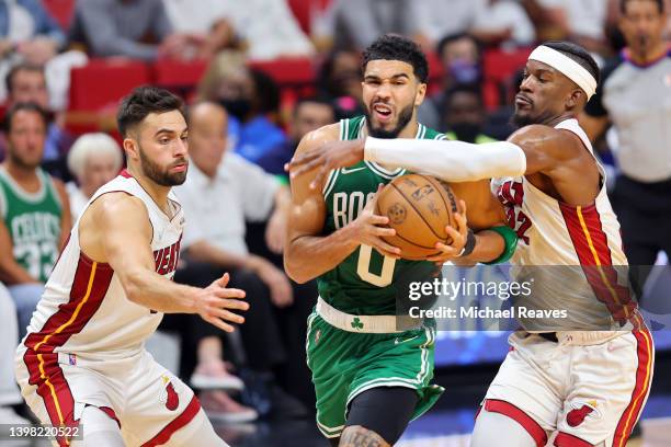 Jayson Tatum of the Boston Celtics drives to the basket against Max Strus and Jimmy Butler of the Miami Heat during the third quarter in Game Two of...