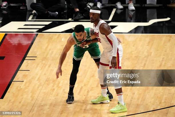 Jayson Tatum of the Boston Celtics guards Jimmy Butler of the Miami Heat during the third quarter in Game Two of the 2022 NBA Playoffs Eastern...