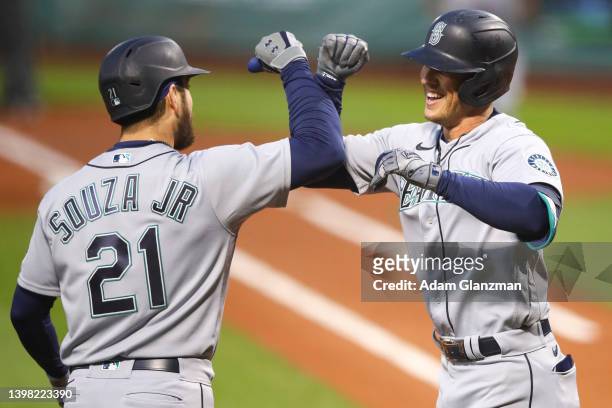 Dylan Moore reacts with Steven Souza Jr. #21 of the Seattle Mariners after hitting a three-run home run in the second inning of a game against the...