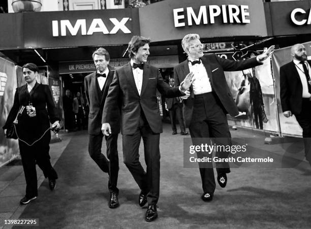 Jerry Bruckheimer, Tom Cruise and Christopher McQuarrie attend The Royal Film Performance & UK Premiere of "Top Gun: Maverick" in Leicester Square on...