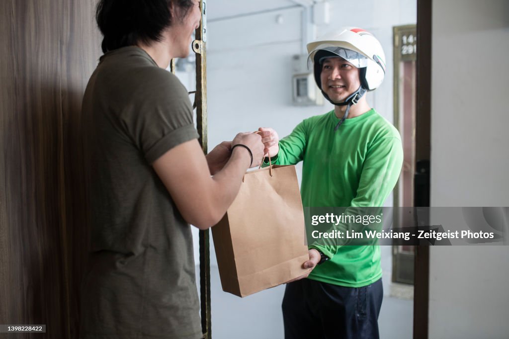 Chinese Delivery Riders Asian Chinese Food Delivery Rider Dressed In Green Delivers Food High ...