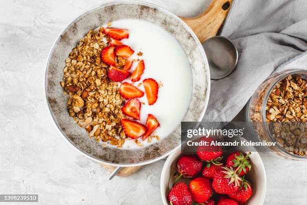 healthy lifestyle breakfast food concept. homemade granola muesli, berries and yogurt in bowl. top view, flat lay - bowl of cereal ストックフォトと画像