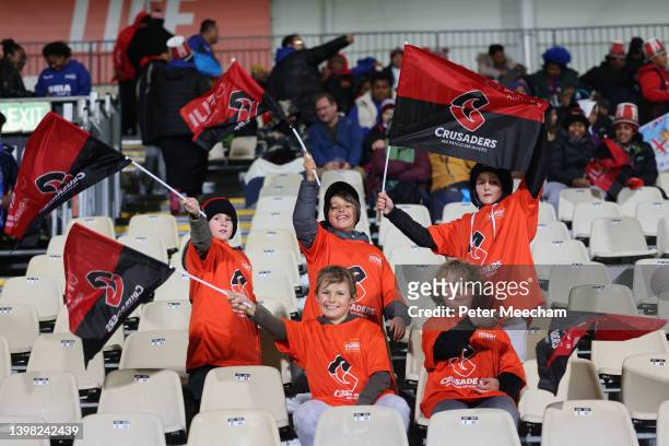 Young fans pose with Chemist Warehouse I Am Hope t-shirts in the stands during the round 14 Super Rugby Pacific match between the Crusaders and the...