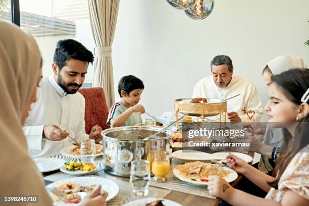 multi-generation saudi family enjoying traditional dishes - saudi home stock pictures, royalty-free photos & images