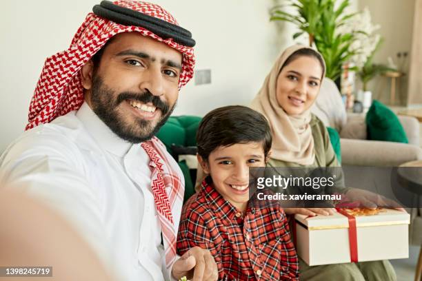 young riyadh family celebrating eid-ul-fitr - woman son stock pictures, royalty-free photos & images
