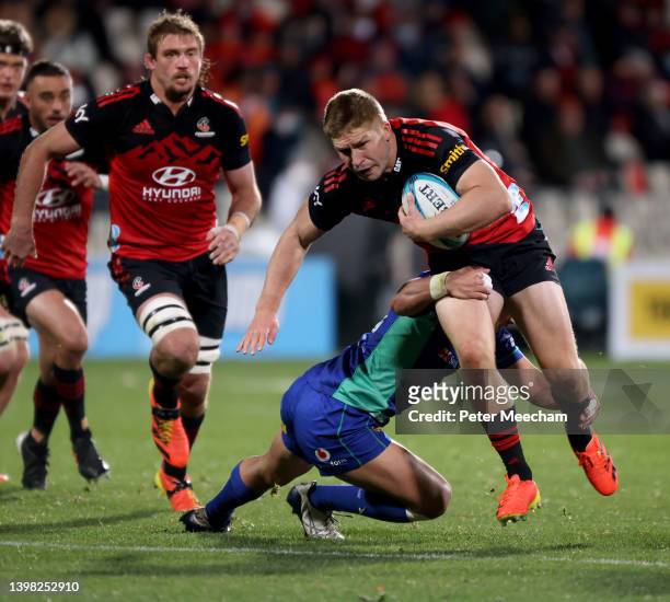 Jack Goodhue of the Crusaders runs with the ball during the round 14 Super Rugby Pacific match between the Crusaders and the Fijian Drua at...