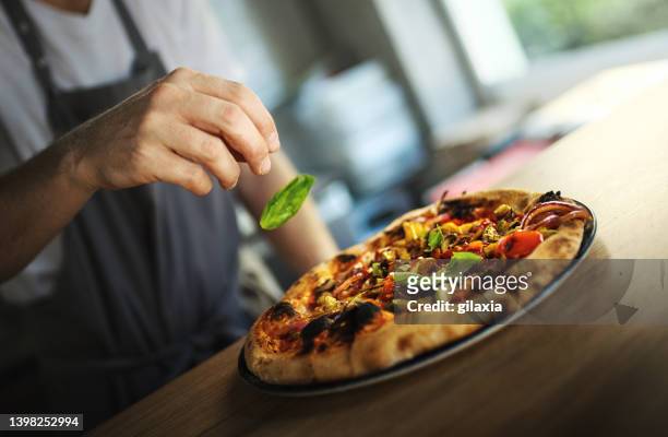 pizza chef serving freshly baked pizza. - artisan stock pictures, royalty-free photos & images