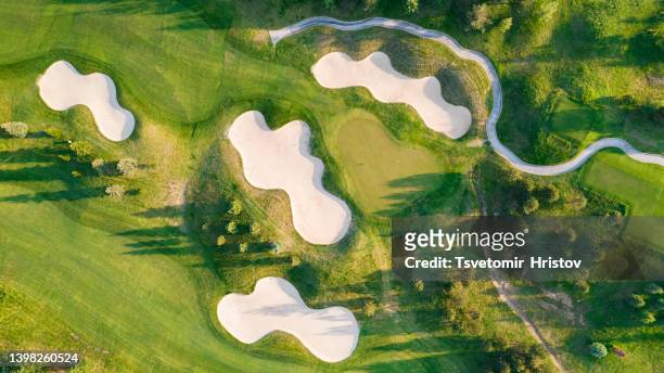 golf course sport, green grass and trees on a golf field, fairway and putting green top view. - golf fotografías e imágenes de stock