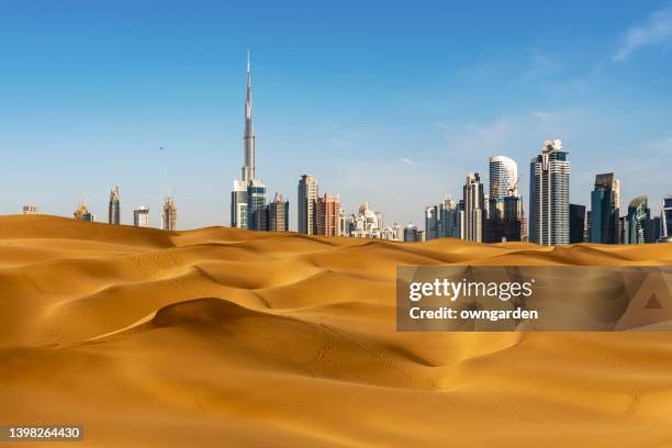 looking along desert towards the business district - dubai ストックフォトと画像