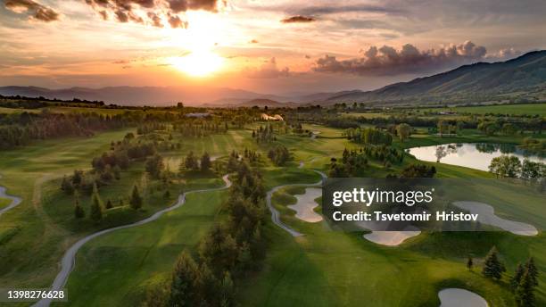 golf course beautiful aerial view of golf field landscape with sunset view. - campo golf fotografías e imágenes de stock