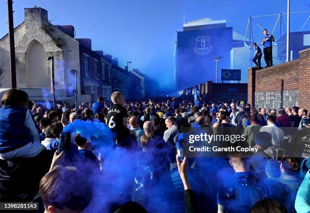 Everton fans hold flares as they welcome their team as they arrive at the stadium prior to the Premier League match between Everton and Crystal...