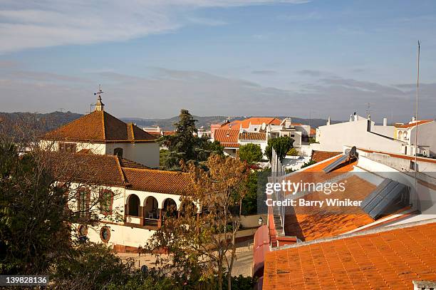 view of roofs and solar panels from castelo silves, castle in silves, the former capital of the moorish province of algarve, near portimao, portugal - silves portugal stock pictures, royalty-free photos & images