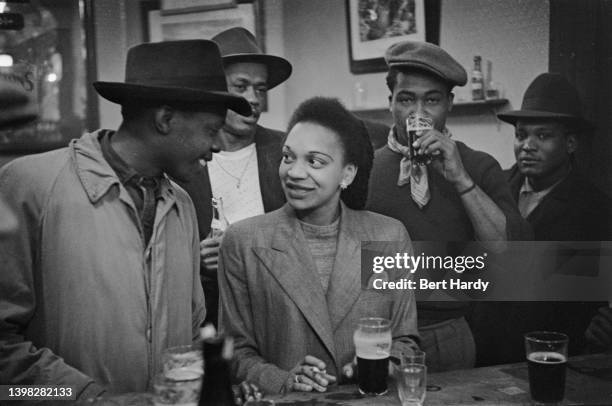 People enjoy a drink at a pub, UK, 1949. Original publication: Picture Post - 4825 - Is There A British Colour Bar? - Vol 44 No 1 - pub. 2nd July 1949
