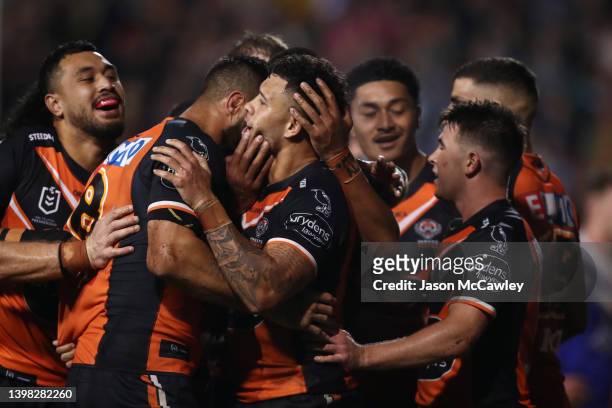 Stardford To'a of the Tigers celebrates with teammates after scoring a try which was later disallowed during the round 11 NRL match between the Wests...