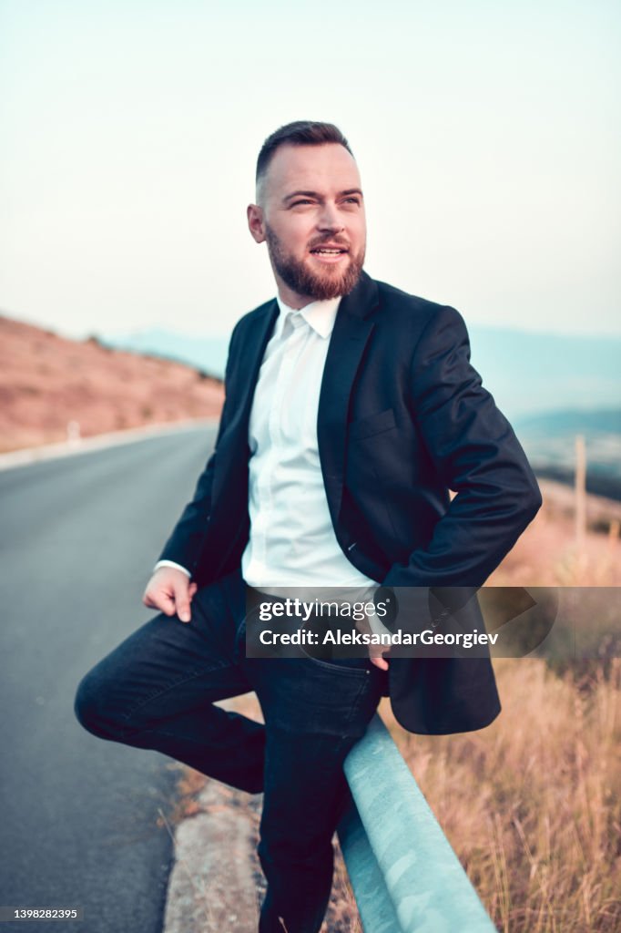 Best Man Waiting For Married Couple On Mountain Road