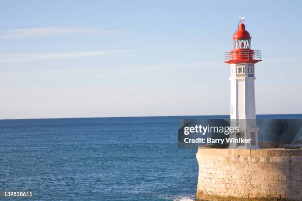 faro, lighthouse, at entrance to port of almeria, andalucia, spain on the mediterranean sea - faro foto e immagini stock