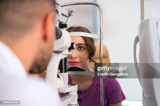 doctor and patient at the ophthalmology clinic - eye exam stock pictures, royalty-free photos & images